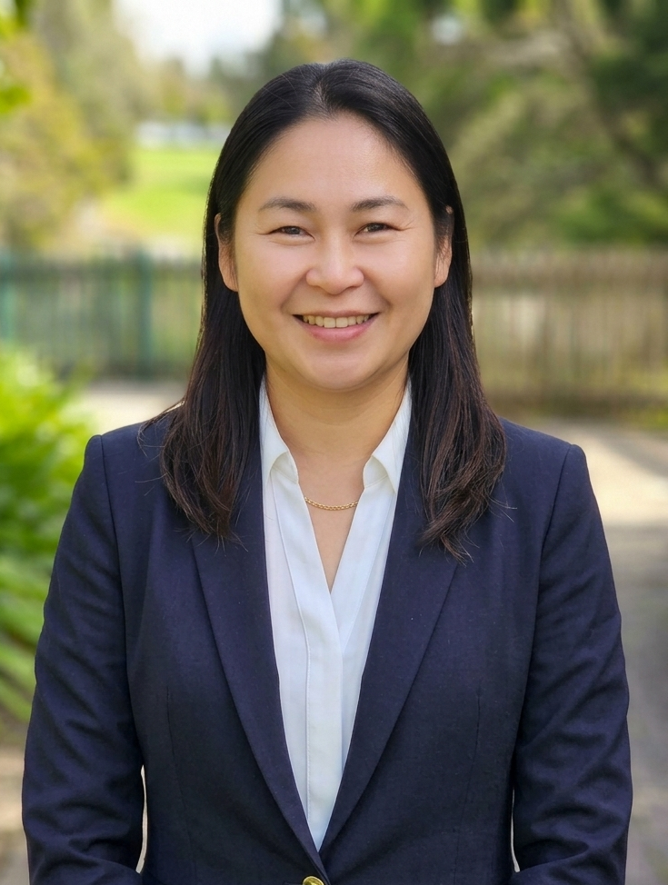 Ni Lar Sim, Director of Sapphire Homes, in a navy blazer and white shirt.